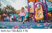 Girl walks toward playground's cheerful hues, a child's adventure awaits. Стоковое AI-видео, аниматор Данила Большаков / Фотобанк Лори