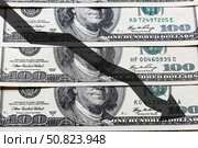 Arrow down on the background of dollar bills. The concept of inflation, depreciation of the dollar or the US economy. Стоковое фото, фотограф Емельянов Евгений Викторович / Фотобанк Лори