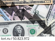 Arrow down on the background of dollar bills. The concept of inflation, depreciation of the dollar or the US economy. Стоковое фото, фотограф Емельянов Евгений Викторович / Фотобанк Лори