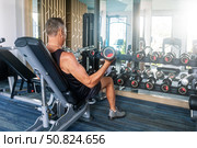 Senior man exercising in gym. Стоковое фото, фотограф Сергей Чуйко / Фотобанк Лори