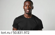 Attractive sexy African American young man wearing a blank cotton black t-shirt isolated on white. Стоковое AI-видео, аниматор Sergey Grishin / Фотобанк Лори