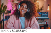 Joyful Sound: A beaming woman immersed in music, showcasing relaxation and enjoyment of audio entertainment. Стоковое AI-изображение, AI-художник Данила Большаков / Фотобанк Лори