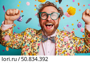 Joyful celebration: man in colorful attire embracing confetti rain with exuberant expression, design for fun event poster. Стоковое AI-изображение, AI-художник Данила Большаков / Фотобанк Лори