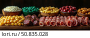 Delicious charcuterie arrangement for fine dinning with curated variety and abundance of savory flavors, ideal snack, party appetizer. Стоковое AI-изображение, AI-художник Данила Большаков / Фотобанк Лори