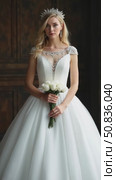 Perfect bride with jewels, a portrait of a girl in a long white dress. Beautiful hair and clean delicate skin. Wedding hairstyle blonde woman. Girl with a white flower in her hands. Стоковое AI-видео, аниматор Sergey Grishin / Фотобанк Лори