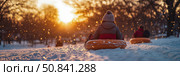 Winter Fun: Child on Sledding Tube at Sunset. Стоковое AI-изображение, AI-художник Данила Большаков / Фотобанк Лори