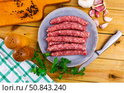 Tasty spiced longaniza, pork sausage with herbs on plate. Стоковое фото, фотограф Яков Филимонов / Фотобанк Лори