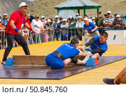 ELANTSY VILLAGE, IRKUTSK REGION, RUSSIA - July 5, 2025: Erdyn Games - festival of nomadic peoples of Eurasia. Wrestlers compete in mas-wrestling - a strength sport of pulling stick. Редакционное фото, фотограф Виктория Катьянова / Фотобанк Лори