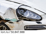Broken car after a crash. Damaged wing and headlamp of a car, scratches on a car body. Стоковое фото, фотограф Емельянов Евгений Викторович / Фотобанк Лори