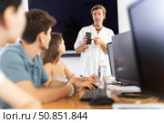 Positive teacher recommending educational mobile app to group of students. Стоковое фото, фотограф Яков Филимонов / Фотобанк Лори
