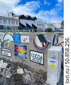 Faial island, Portugal - September 23, 2023: A painted wall at Horta Marina on Faial Island, Azores, covered with murals left by sailors. Редакционное фото, фотограф Софья Соломонова / Фотобанк Лори
