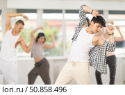 Young guy practicing basic hip hop moves in training hall. Стоковое фото, фотограф Яков Филимонов / Фотобанк Лори