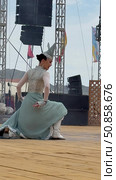 ELANTSY, IRKUTSK REGION, RUSSIA - July 5, 2025: Erdyn Games - festival of nomadic peoples of Eurasia. Vertical video of beautiful girl in ethnic dress dancing Buryat folk dance on an open stage. Редакционное видео, видеограф Виктория Катьянова / Фотобанк Лори
