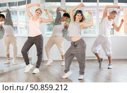 Young girl practicing basic hip hop moves in training hall. Стоковое фото, фотограф Яков Филимонов / Фотобанк Лори