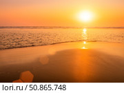A colorful sunset or sunrise on the seaside with a sandy beach with impurities of volcanic ash. Mandrem, Goa, India. (2018 год). Стоковое фото, фотограф Емельянов Евгений Викторович / Фотобанк Лори