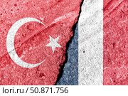 The crack between France and Turkish flags. The concept of sanctions, problems, severance of diplomatic relations and confrontation. Стоковое фото, фотограф Емельянов Евгений Викторович / Фотобанк Лори