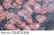 Pork Butt sliced on BBQ. Shish kebab. Pieces of pork on the grid, grilled meat with smoke. Food preparation process. Marinated spiced fillet meat cooked on charcoal barbeque grill. Outdoors cooking. Стоковое видео, видеограф Марина Демидюк / Фотобанк Лори