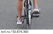 Woman pedaling on stationary bicycle during sports day. Стоковое видео, видеограф Mikhail Davidovich / Фотобанк Лори