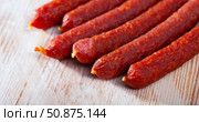 Tyrolean sausages and peppercorns on wooden table. Стоковое фото, фотограф Яков Филимонов / Фотобанк Лори