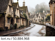 Wet street winding through charming cotswolds village on a foggy day. Стоковое AI-изображение, AI-художник Иван Рябоконь / Фотобанк Лори