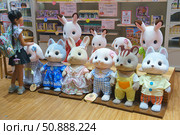 Tokyo, Japan - Oct 13 2024, A close-up view of a little Japanese girl looking at giant figures of cute animals from the Sylvanian Families or Calico Critters toy series in a toy store, Tokyo, Japan. Редакционное фото, фотограф Сергей Богомяко / Фотобанк Лори