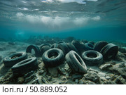Underwater environmental disaster, dumped tires polluting ocean floor. Стоковое AI-изображение, AI-художник Иван Рябоконь / Фотобанк Лори