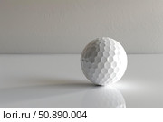 White golf ball resting on reflective surface with textured background. Стоковое AI-изображение, AI-художник Иван Рябоконь / Фотобанк Лори