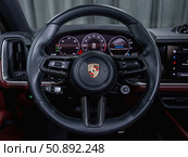 Novosibirsk, Russia -  July 14, 2025: Porsche Cayenne,  Prestige car interior with dashboard, steering wheel, speedometer and tachometer. Редакционное фото, фотограф Виталий Сова / Фотобанк Лори