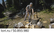 Worker Splitting Firewood with Splitting Axe in Forest - Traditional Wood Chopping and Log Splitting on Tree Stump - Manual Timber Processing in Woodland outdoor wood chopping, summer countryside day. Стоковое видео, видеограф Сергей Тимофеев / Фотобанк Лори