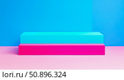 Vibrant geometric pedestal set for product presentation, featuring contrasting colorful blocks in blue, pink, and turquoise against a bright wall, suitable for promotional banners or abstract art. Стоковое AI-изображение, AI-художник Данила Большаков / Фотобанк Лори