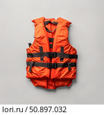 Orange life vest ensuring safety during water activities. Стоковое AI-изображение, AI-художник Иван Рябоконь / Фотобанк Лори