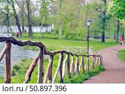 A fence made of untreated poles in the Park. Soft focus. Стоковое фото, фотограф Константин Тимофеев / Фотобанк Лори