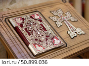Russia, Krasnodar, 2017: Decorated with old book Bible and a cross of gold and red colors. Стоковое фото, фотограф Наталия Кирсанова / Фотобанк Лори