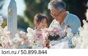 Family Remembrance: An elderly man and a little girl with a bouquet visiting a memorial site, remembering lost loved ones. Стоковое AI-изображение, AI-художник Данила Большаков / Фотобанк Лори