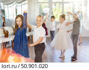 Tween girls ad boys dancing slow partner dance during festive event. Стоковое фото, фотограф Яков Филимонов / Фотобанк Лори