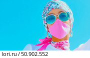 Concept: Fashionable protection. Woman with scarf, sunglass and face covering against bright sky. Стоковое AI-изображение, AI-художник Данила Большаков / Фотобанк Лори