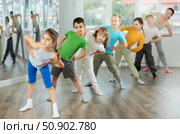 Juvenile girl engaged in choreography exercises together with children's group. Стоковое фото, фотограф Яков Филимонов / Фотобанк Лори