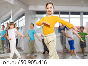 Girl learn to dance modern dances, doing movement with unrecognizable teacher. Стоковое фото, фотограф Яков Филимонов / Фотобанк Лори