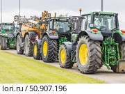 Row of Heavy Duty Agricultural Tractors. Kaunas, Lithuania, 19 June 2025. Редакционное фото, фотограф Zydrius Tartenis / Фотобанк Лори