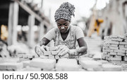 Laborious profession: A woman focused on building a brick wall on a construction site. Стоковое AI-изображение, AI-художник Данила Большаков / Фотобанк Лори
