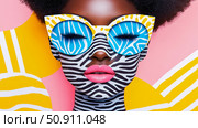 Abstract art portrait of dark-skinned woman with Afro hairstyle, bold zebra pattern on face and artistic glasses with blue and white stripes. Стоковое AI-изображение, AI-художник Данила Большаков / Фотобанк Лори