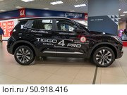 Car Presentation: Black Tiggo 4 Pro displayed in showroom with retail shops in the background, car show for promotion, sales, advertisement. Витебск, Беларусь. Редакционное фото, фотограф Данила Большаков / Фотобанк Лори