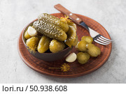 Tasty homemade cucumbers in a brown ceramic bowl on a gray textured background. Стоковое фото, фотограф Ольга Лепёшкина / Фотобанк Лори