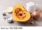 Ingredients: pumpkin, onion, garlic, sour cream, vegetable oil, salt and black pepper on beige textured stone background for cooking a delicious vegetarian dish. Стоковое фото, фотограф Ольга Лепёшкина / Фотобанк Лори