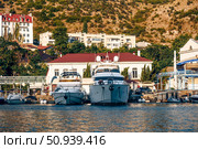 Balaklava, Crimea, 21 Jule 2020, Boats in port of seaside city on Black Sea. Редакционное фото, фотограф Spirit River / Фотобанк Лори