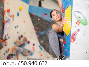 Young girl climbing without ropes and harnesses on bouldering wall. Стоковое фото, фотограф Яков Филимонов / Фотобанк Лори