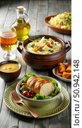 A Rustic Tavern Table Setting With Creamy Soup, Roasted Chicken, and Fresh Salad. Generative AI. Стоковое AI-изображение, AI-художник Roman Zavorotny / Фотобанк Лори