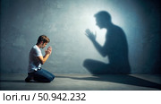 Man Mimicking Hypocritical Prayer Posture in Front of Shadow. Generative AI. Стоковое AI-изображение, AI-художник Roman Zavorotny / Фотобанк Лори