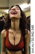 Pure Joy: A woman with long, dark hair throws her head back in laughter, showcasing unbridled happiness and freedom, a moment of genuine amusement. Стоковое AI-изображение, AI-художник Данила Большаков / Фотобанк Лори