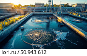 Industrial wastewater treatment plant purifying water before it is discharged. Стоковое AI-изображение, AI-художник Anastasy Yarmolovich / Фотобанк Лори